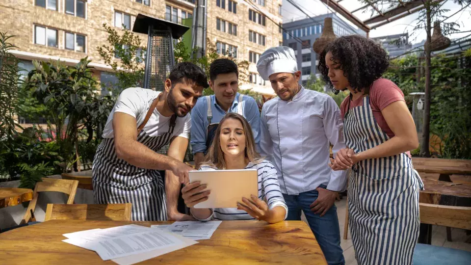 Restaurant staff reviewing their menu